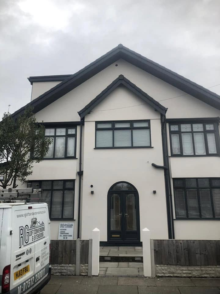 Same house after RG renovation — fresh render, new grey windows and bespoke arched porch