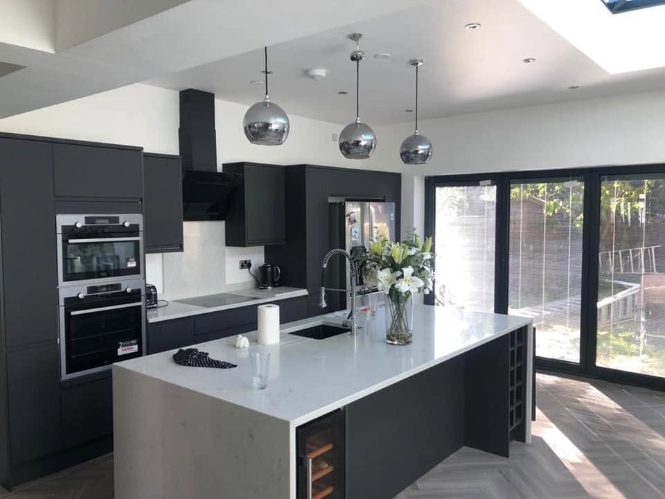 Black gloss kitchen extension with island and bi-fold doors — RG Lancashire